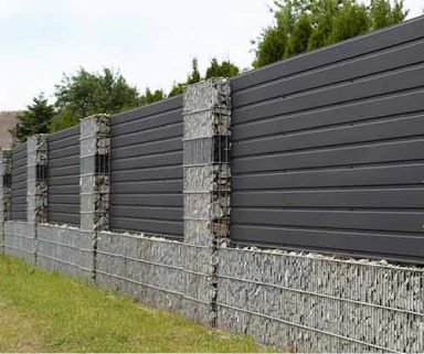 Horizontal metal fence with gabion stone pillars